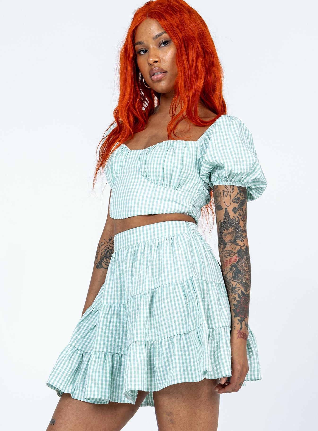 Matching set Gingham print  Crop top  Puff sleeves  Back tie fastening  Shirred back  High waisted mini skirt  Elasticated waistband  Lined top 