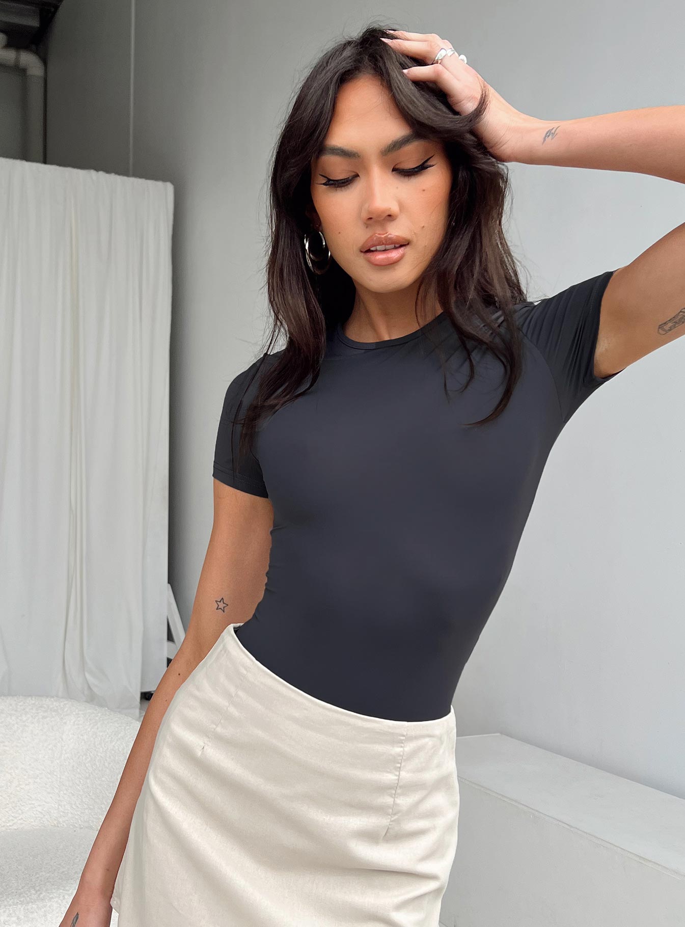 side view of model wearing Princess Polly Rover Bodysuit Grey Short Sleeves Crew Neck 