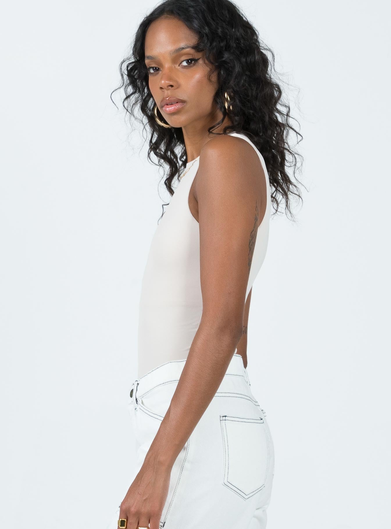 side view of model wearing Princess Polly Fischer Bodysuit Bone Sleeveless High Neck 
