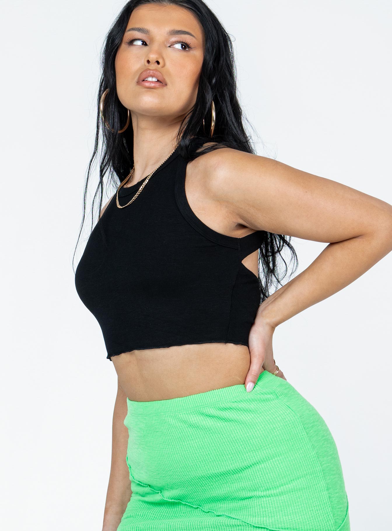 side view of model wearing Princess Polly Reynor Top Black Sleeveless High Neck 