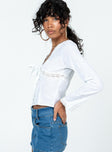 Long sleeve shirt Embroidered detail material V-neckline Button & tie fastening at front Knit lace throughout
