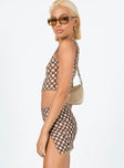   side view of model wearing Princess Polly Motel Pelma Mini Skirt Chain Tangle Beige 