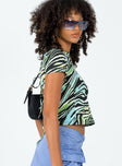 side view of model wearing Princess Polly Motel Surtie Top Warped Zebra Blue Short Sleeves Crew Neck 