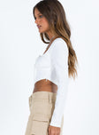 White long sleeve top Square neckline Inner silicone strip at shoulders Tie fastening at front Boning through front Pointed hem