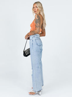 side view of model wearing Princess Polly Maple Flare Jeans Knee Rips Light Wash Denim Mid Rise 