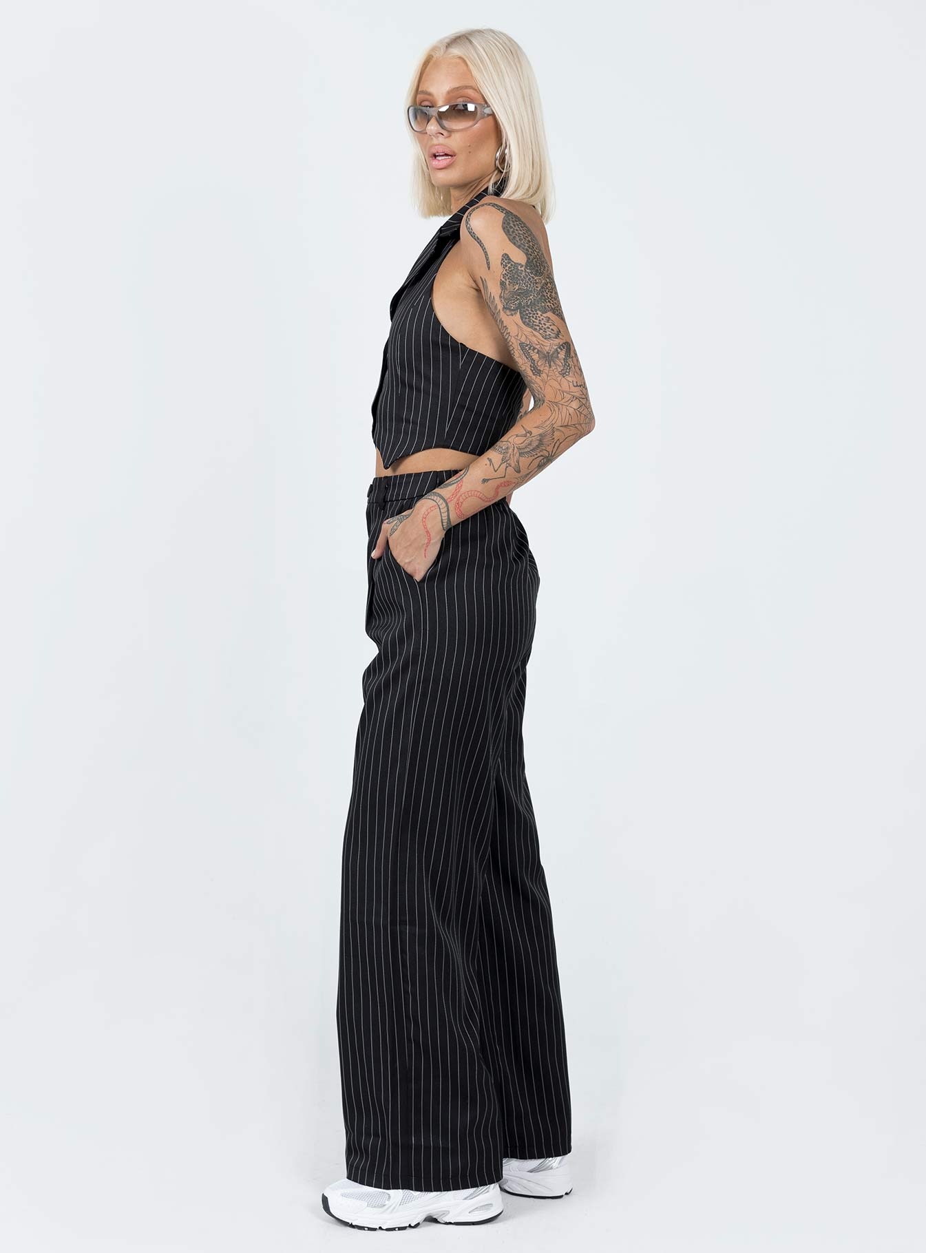 Matching set Pinstripe print  Vest top  Lapel collar  Button front fastening  High waisted pants  Zip & button fastening  Belt looped waist  Twin hip pockets  Elasticated back Wide leg 
