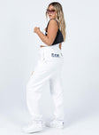 side view of model wearing Princess Polly Jasmine Graphic Track Pants White 