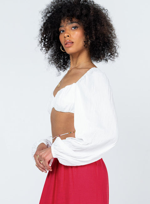side view of model wearing Princess Polly Kerry Long Sleeve Top White 