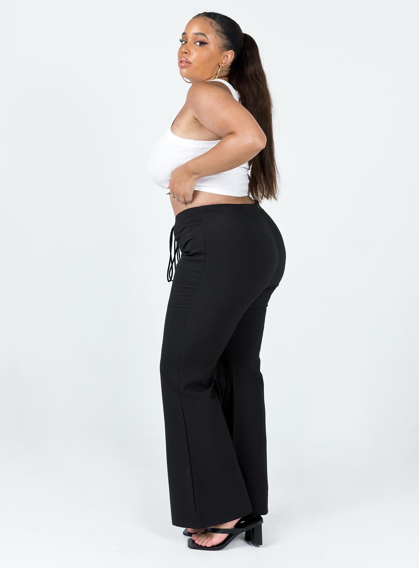 side view of model wearing Princess Polly Lovey Pants Black Curve 