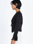 Black long sleeve top Silky material Open front Tie fastening Ruched bust Lace detailing Flared cuff