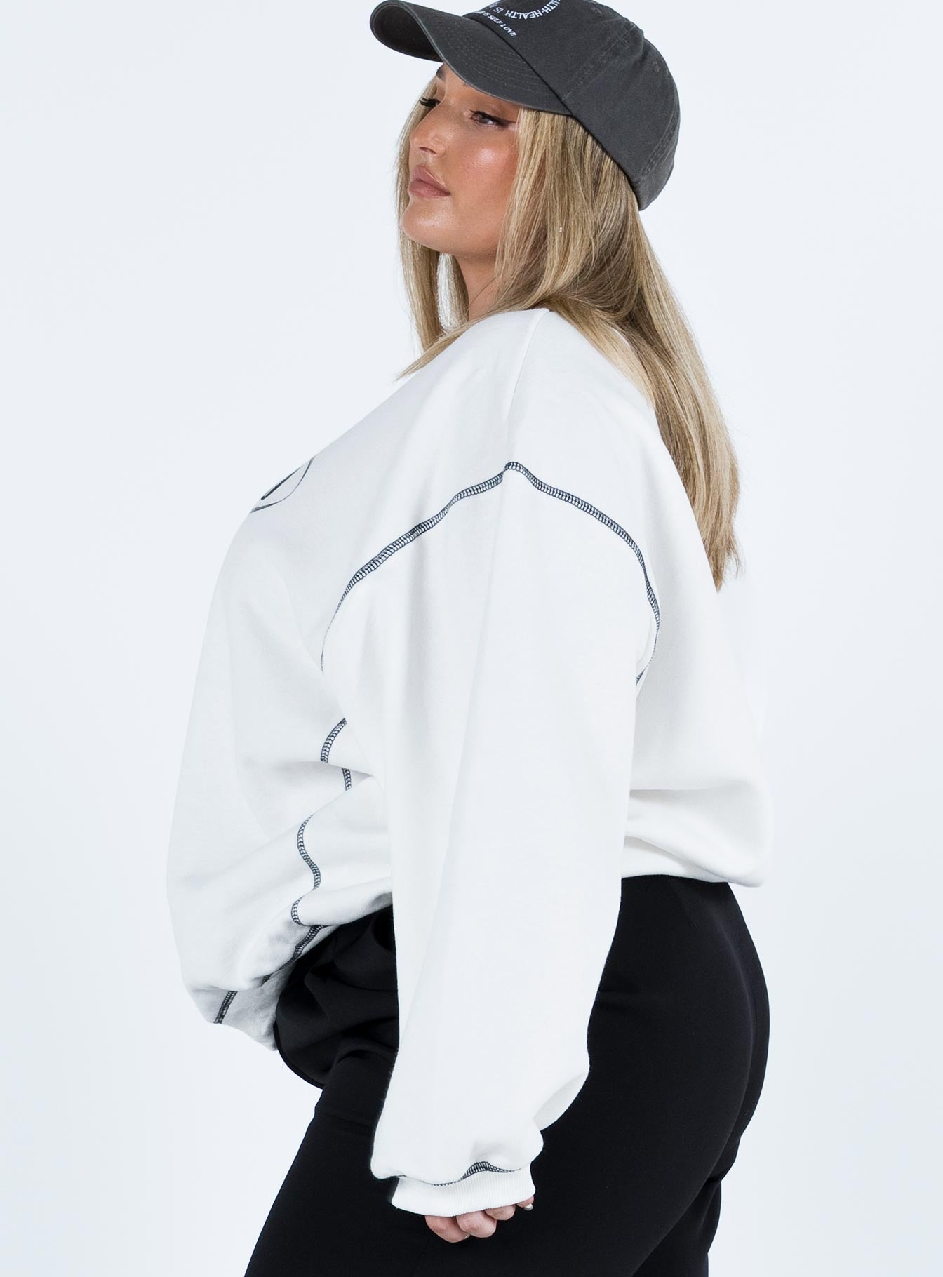 side view of model wearing Princess Polly Portland Oversized Sweatshirt White Curve regular 