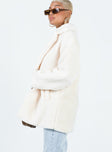 Shearling coat Faux fur material Lapel collar Single button fastening Twin hip pockets