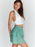   side view of model wearing Princess Polly Greta Mini Skirt Green 