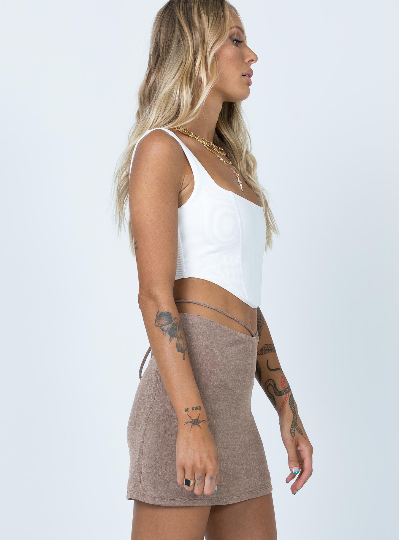   side view of model wearing Princess Polly Maisie Mini Skirt Brown 