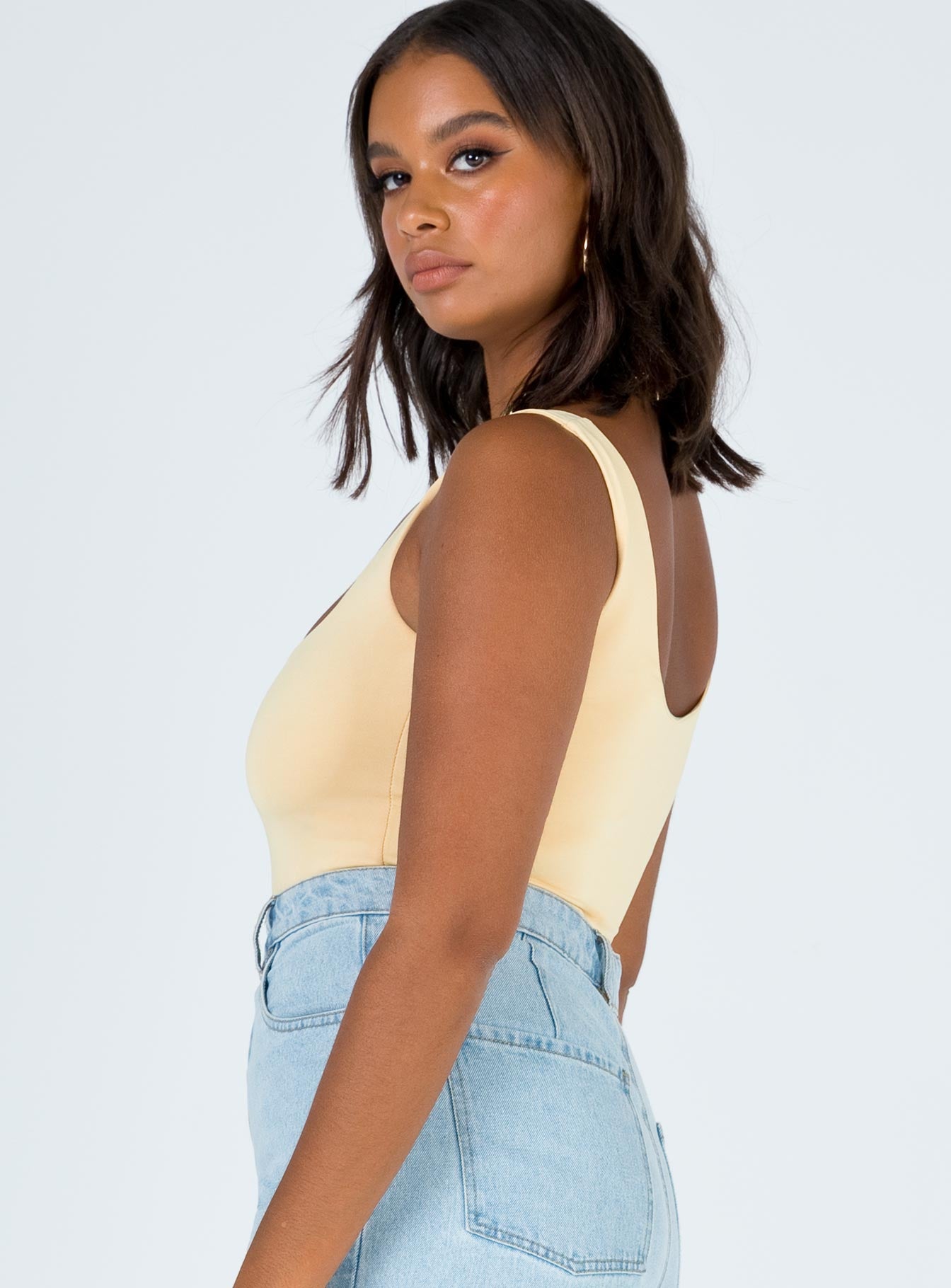 side view of model wearing Princess Polly Tamikah Bodysuit Sleeveless Scoop Neck 