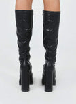 Knee high boots Faux leather material Platform base Rounded toe Zip fastening at side Block heel Padded footbed