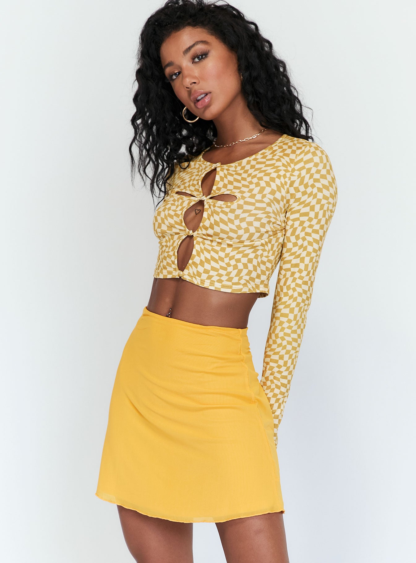   side view of model wearing Princess Polly Baxter Mini Skirt Orange 