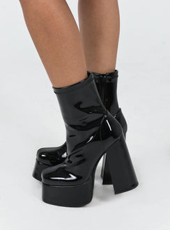 Platform boots Faux patent leather material Zip fastening at side Block heel Rounded toe Padded insole 
