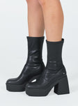 Boots  Faux leather material  Fitted at leg  Block heel  Platform base  Square toe  Slight stretch 