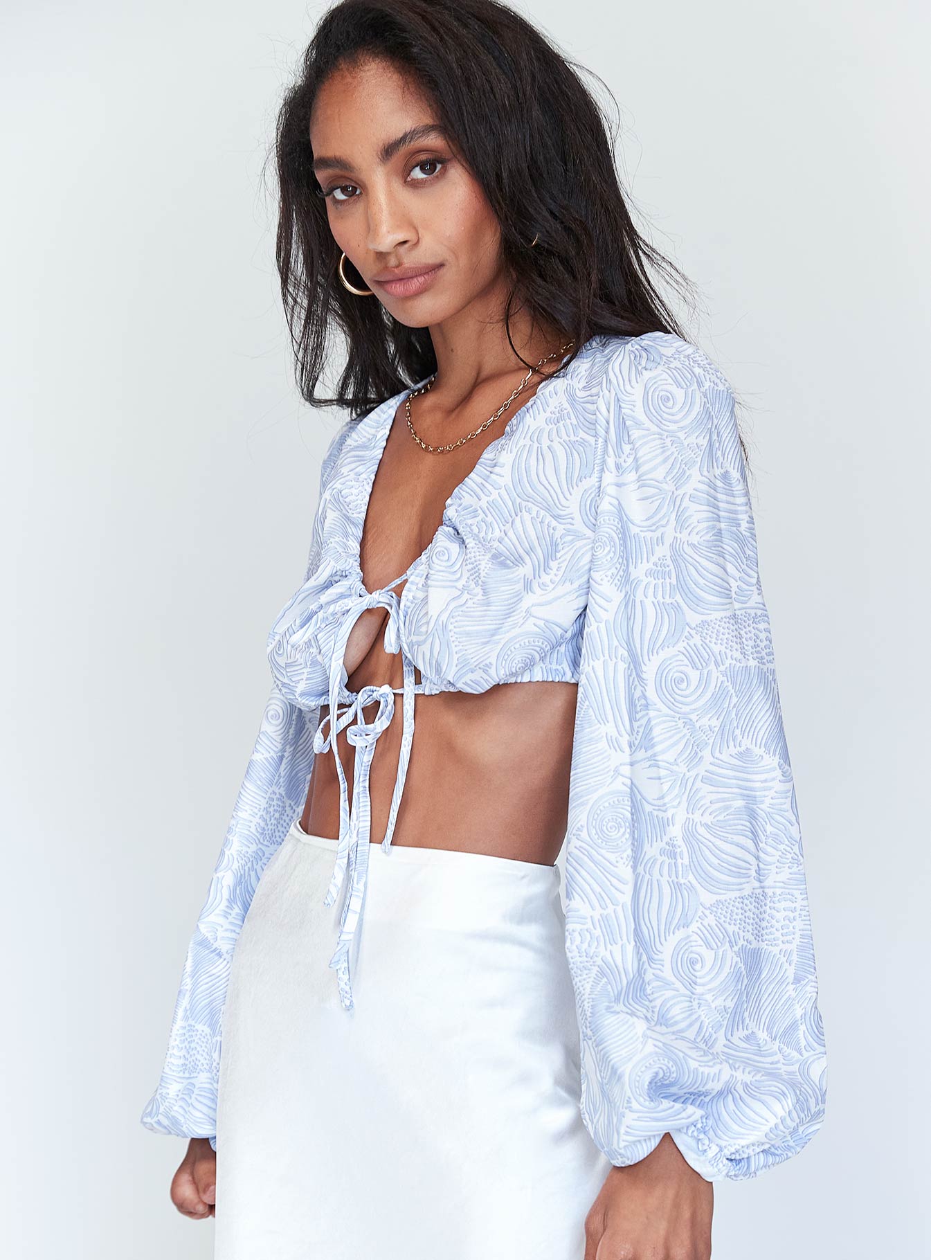 side view of model wearing Princess Polly Lyric Long Sleeve Crop Top Blue 