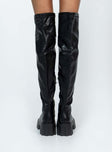 Thigh high boots Faux leather material Platform base Rounded toe Zip fastening at 