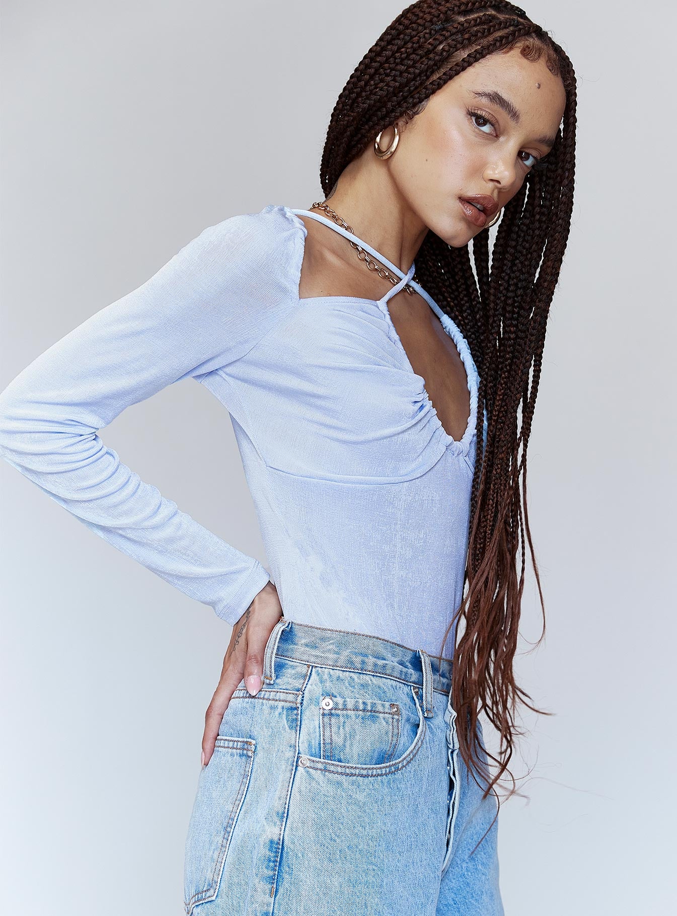 side view of model wearing Princess Polly Claire Bodysuit Blue Full Sleeves Asymmetric Neckline 