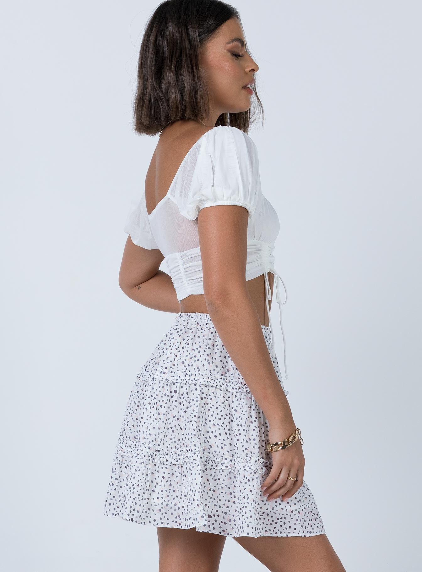   side view of model wearing Princess Polly Rasmus Mini Skirt White 