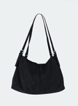 Black bag Canvas material  Silver hardware  Flat base Removable and adjustable straps  Single internal compartment 