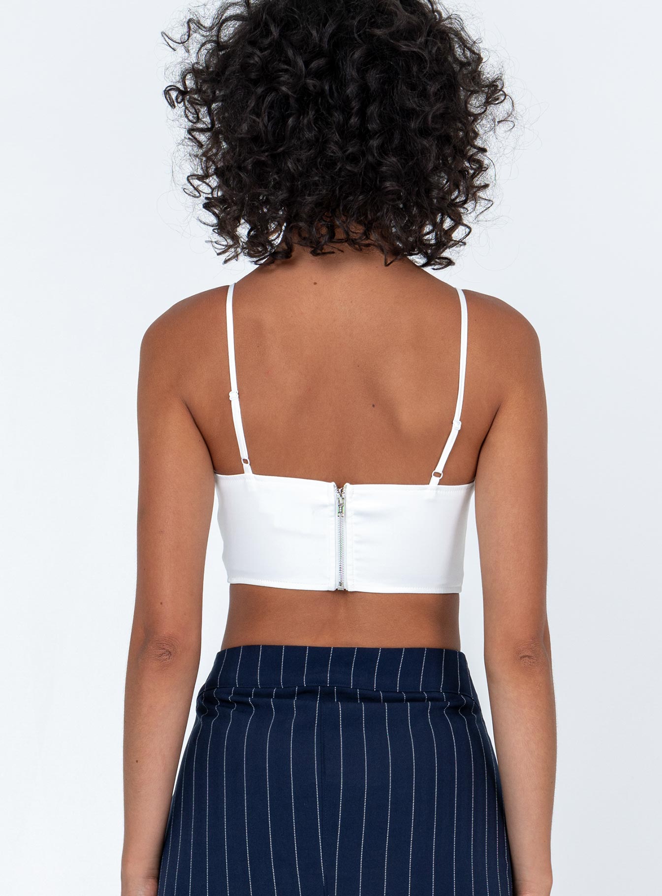 back view of model wearing Princess Polly Ashbourne Top White Sleeveless Plunger 