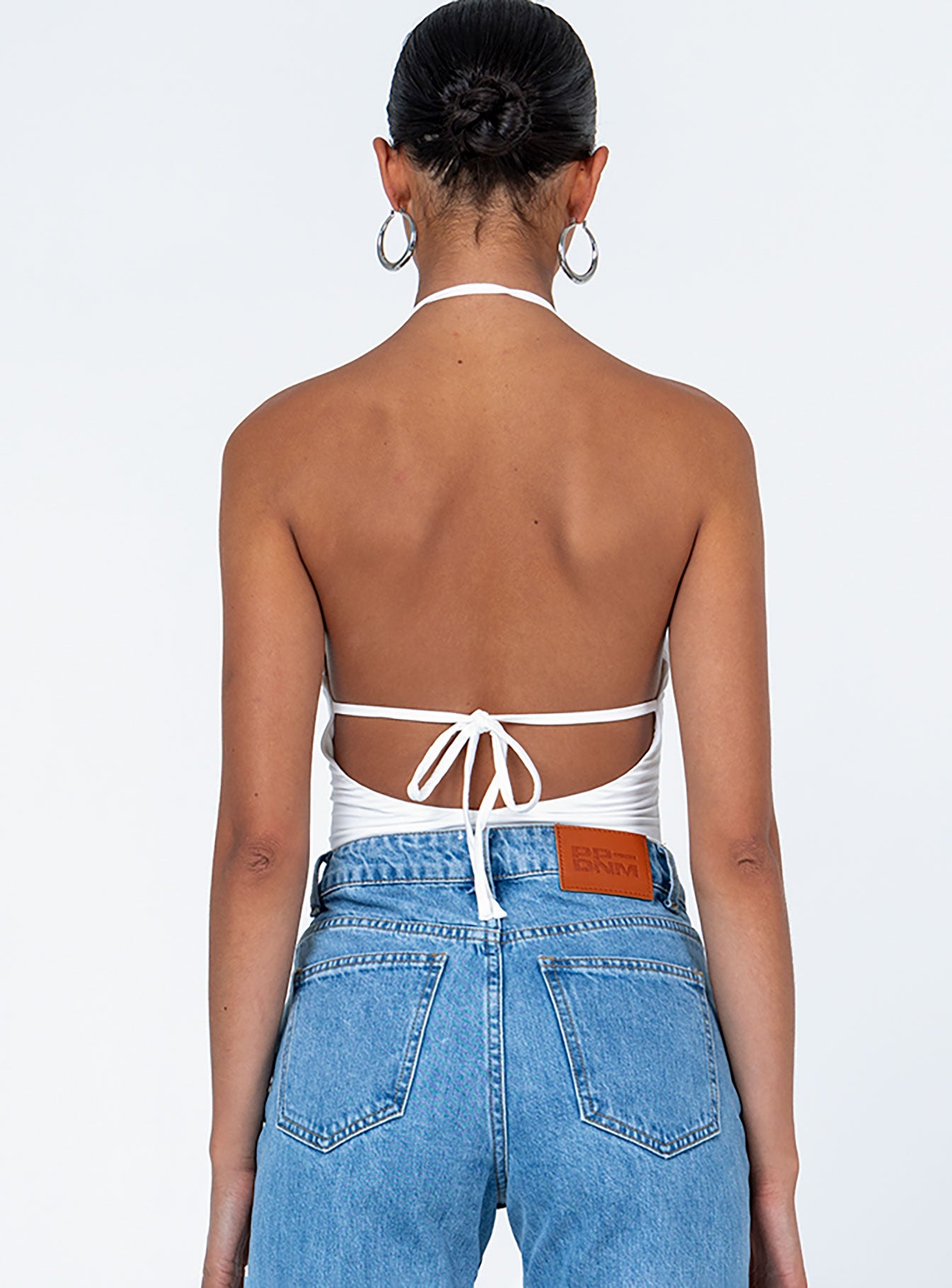 back view of model wearing Princess Polly Ellamay Bodysuit White Sleeveless Asymmetric Neckline 