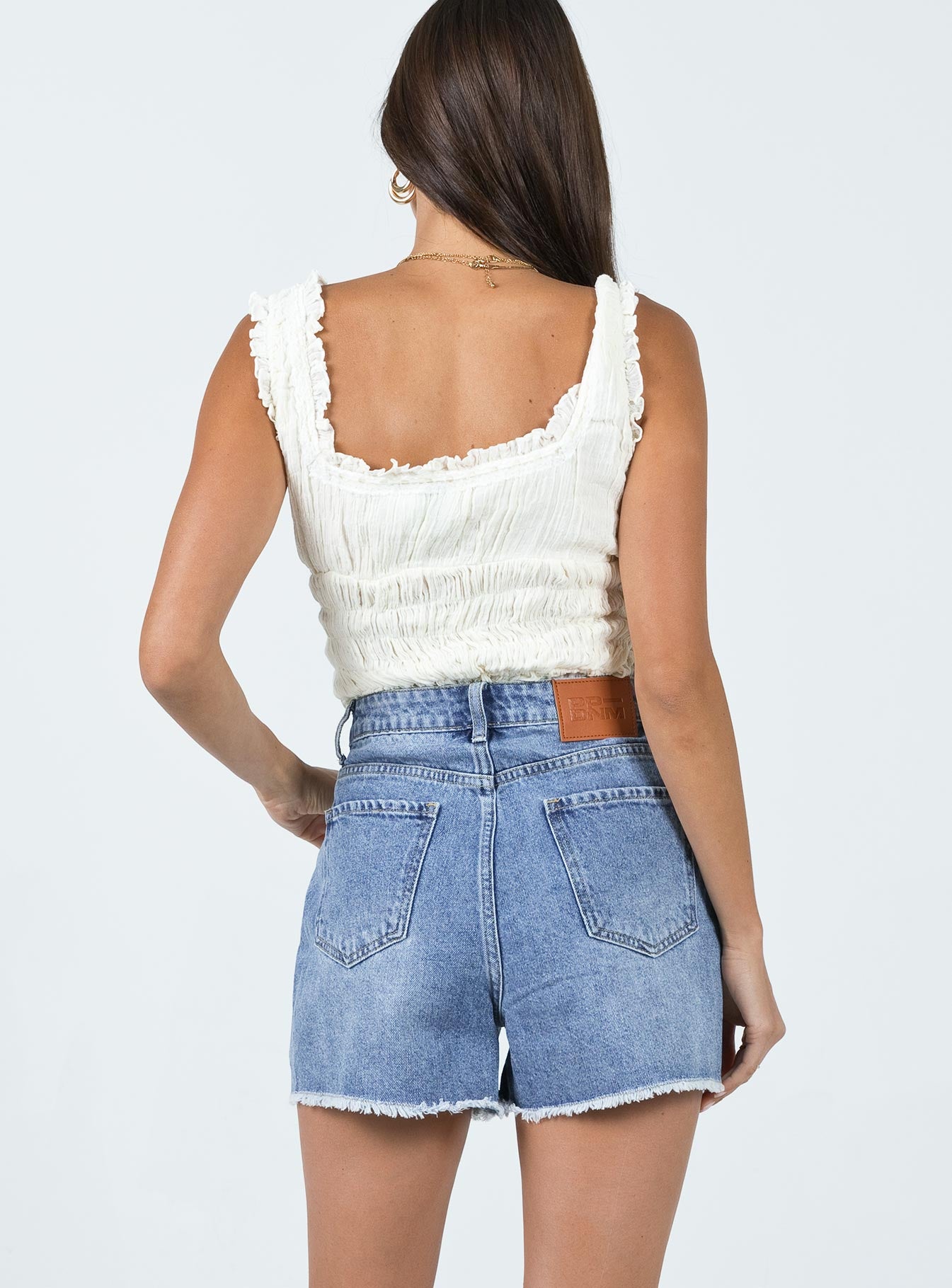 Denim shorts Mid wash denim High waisted design Belt looped waist Zip & button fastening Classic five-pocket design Raw edge hem