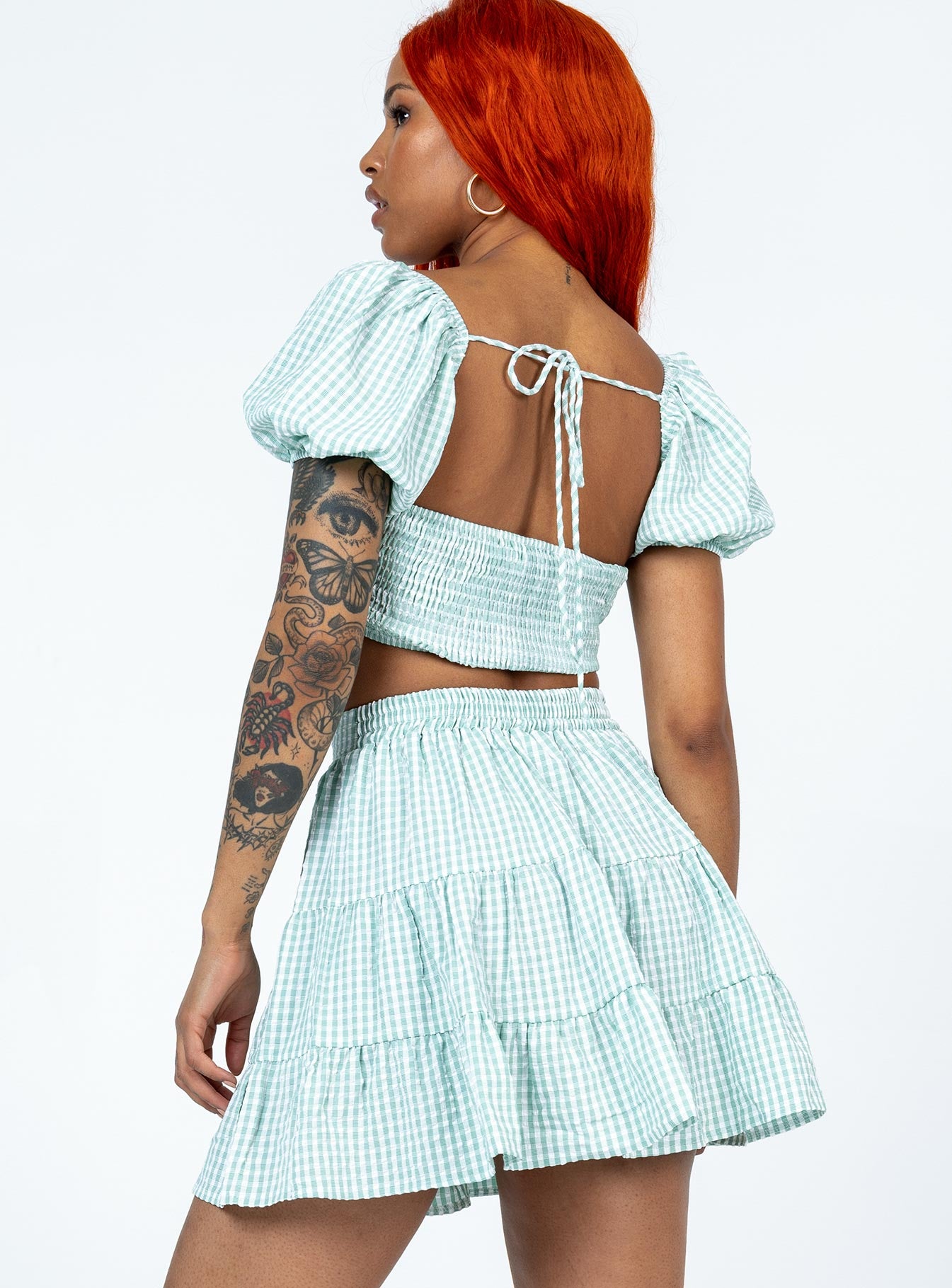 Matching set Gingham print  Crop top  Puff sleeves  Back tie fastening  Shirred back  High waisted mini skirt  Elasticated waistband  Lined top 