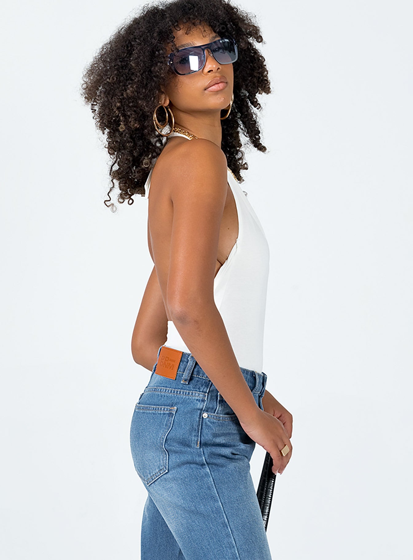 side view of model wearing Princess Polly Allie Halter Bodysuit White Sleeveless High Neck 