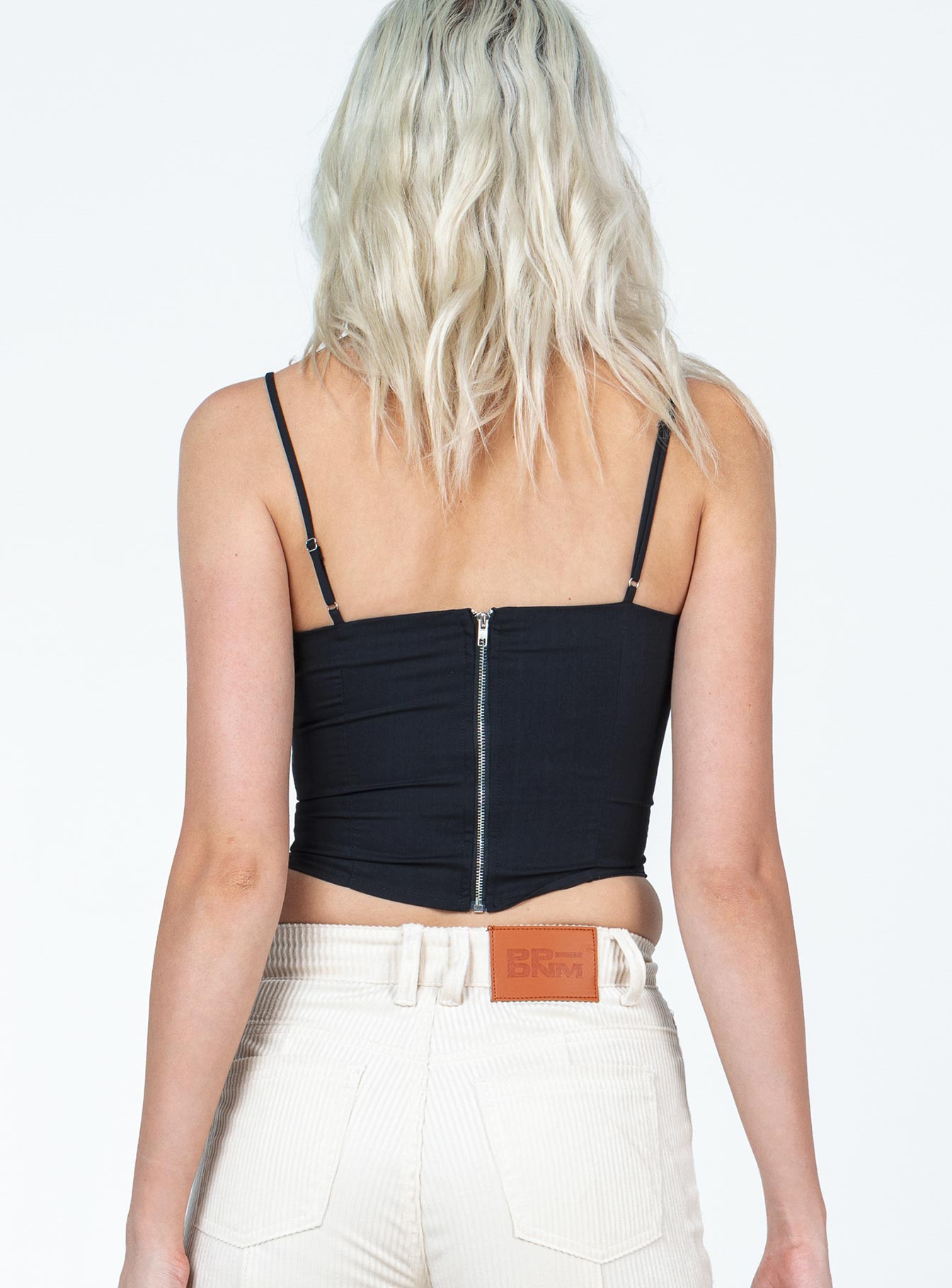 back view of model wearing Princess Polly Durant Top Black Sleeveless Sweetheart 