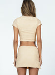 Beige matching set Detailed material  Cropped tee Low-rise mini skirt  Elasticated waistband  Side slit 
