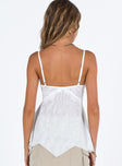 White top Sheer mesh material Adjustable shoulder straps Layered hem Slight stretch