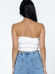 Strapless top Ruffle neckline  Pearl button front fastening  Elasticated throughout 
