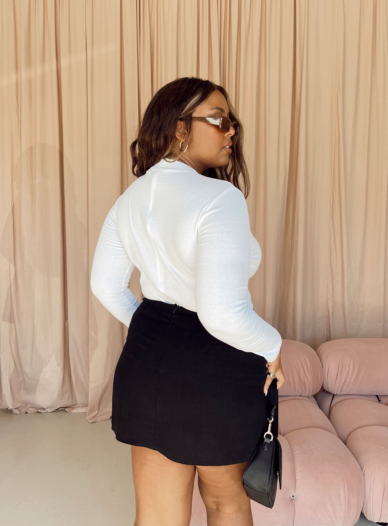 back view of model wearing Princess Polly Maleny Long Sleeve Bodysuit White Curve Full Sleeves Crew Neck 