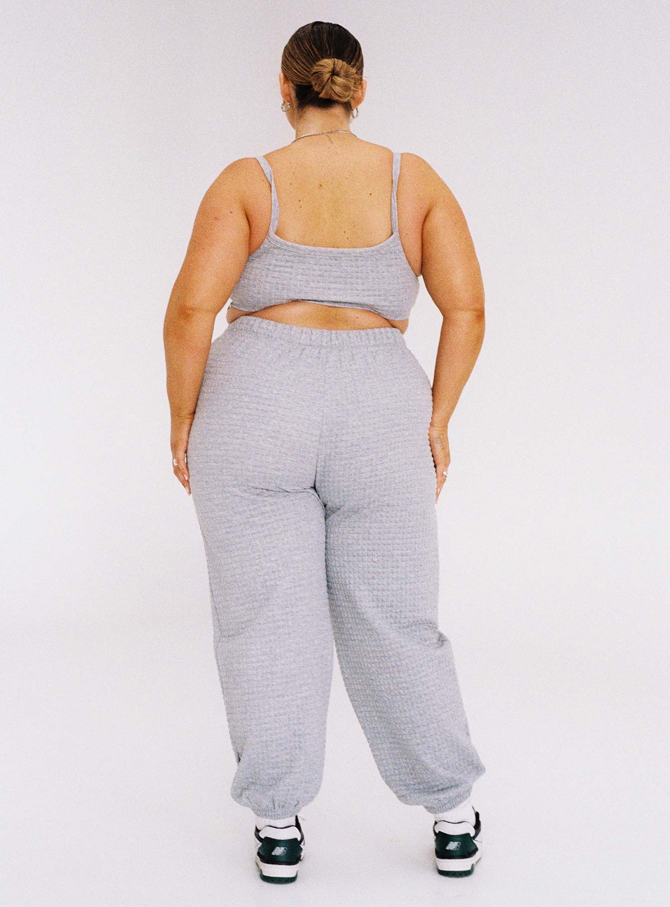 Grey matching set Track style Quilted material Crop top Fixed straps Wide neckline Invisible zip fastening at side High waisted pants Elasticated ankles Relaxed leg Elasticated waistband