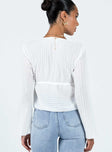 Long sleeve top Sheer pleated material V-neckline Tie fastening at bust Flared sleeves