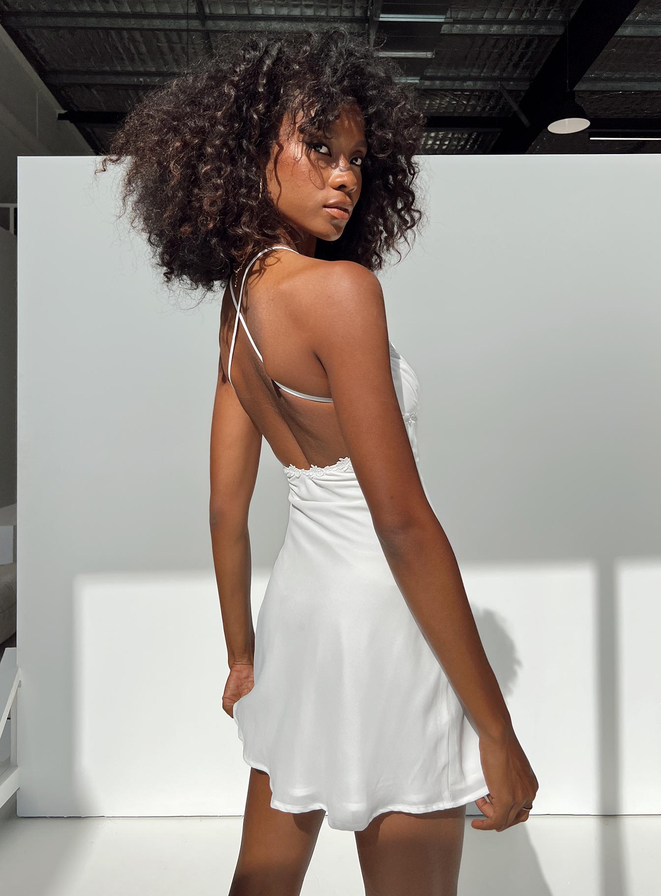 Front view of model wearing  front Princess Polly High Neck  Maylor Mini Dress White