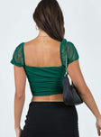 back view of model wearing Princess Polly City Lights Crop Top Green Short Sleeves Square Neck 