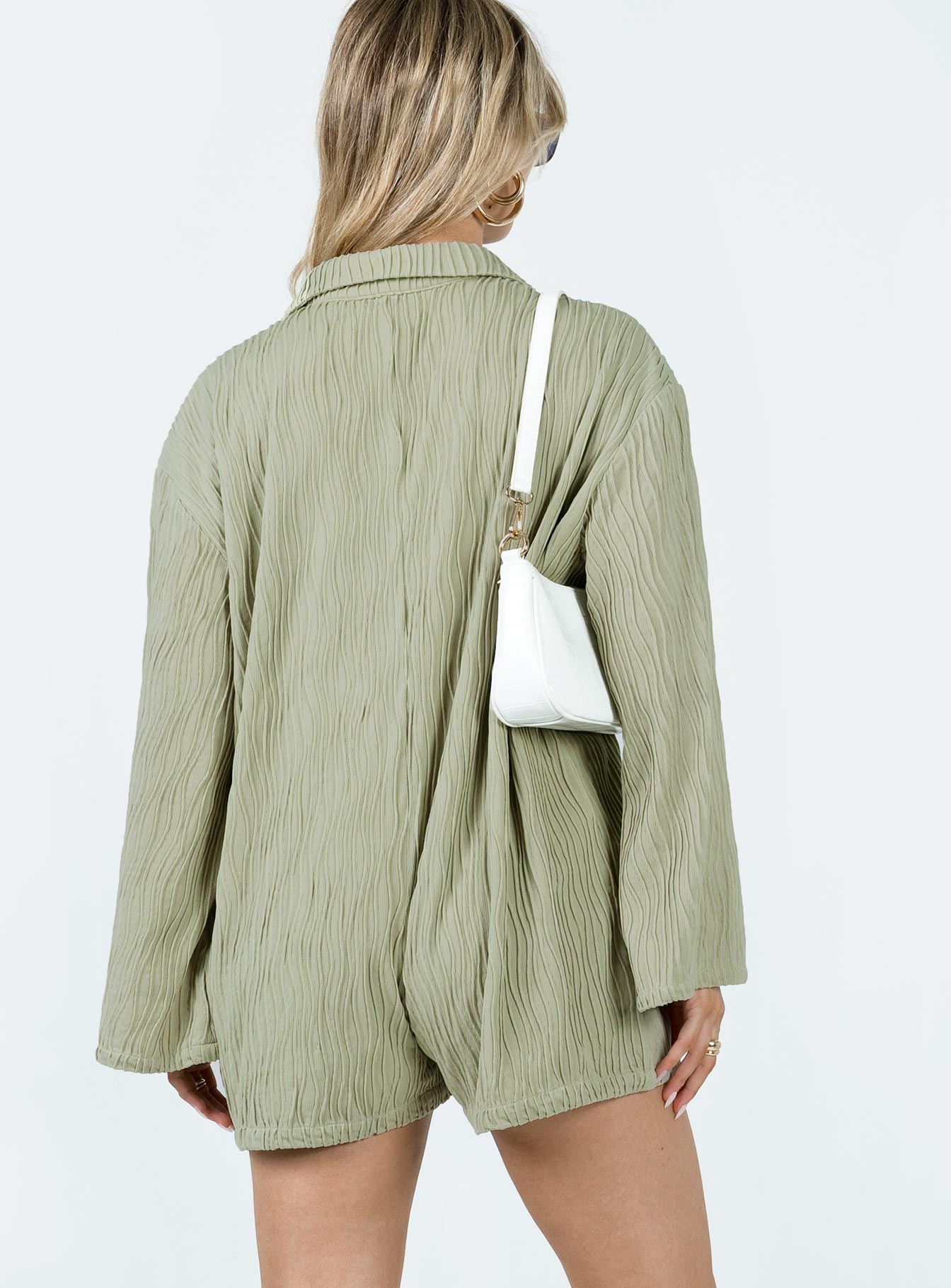 Long sleeve romper Textured material  Classic collar Button fastening at front Good stretch