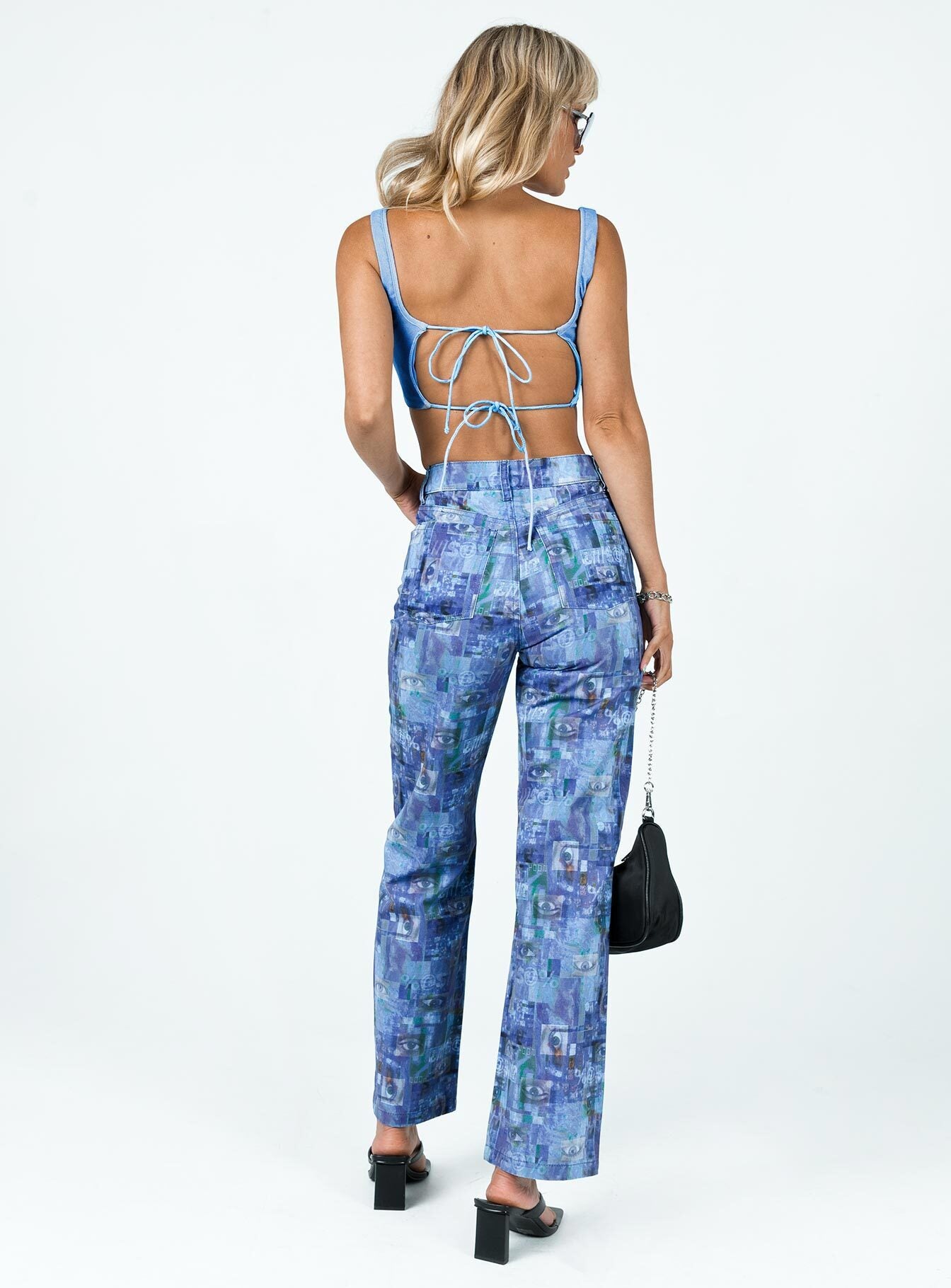 back view of model wearing Princess Polly The Ragged Priest Info Flares Drill Blue 