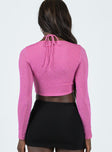 Long sleeve crop top Sparkly material Cross-halter neck tie Cut out at front Split hem 