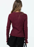 Long sleeve top Ribbed knit material  Low cut neckline  Split front hem  Good stretch  Unlined 