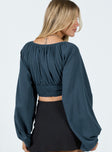 Long sleeve top V-neckline Balloon style sleeves Shirred waistband Button detail at font