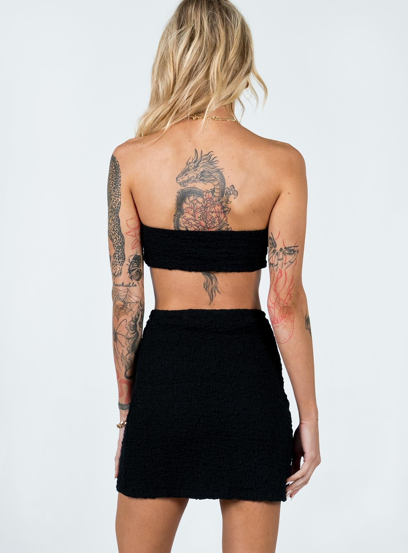 Matching set  Slim fitting  50% nylon 40% rayon 10% elastane  Crinkle material  Crop top  Tie front fastening  Inner silicone strip at bust  High waisted mini skirt  Elasticated waistband Invisible zip fastening at side 