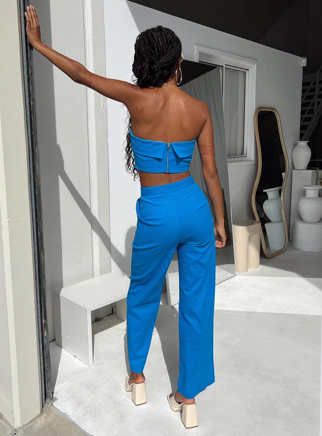 Matching set Strapless top  Inner silicone strip at bust  Zip fastening at back  High waisted pants  Hook & zip fastening  Twin hip pockets  Wide leg 