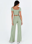 Two piece set Knit ribbed material Crop top Inner silicone strip along shoulders Wide neckline High waisted pants Thick elasticated waistband Twin hip pockets Wide flared leg